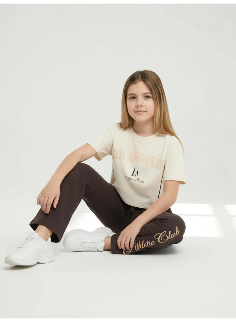 فكتور اند جين طقم بناتي قطعتين تي شيرت بطبعة لوس أنجلوس وبنطلون واسع - بيج وبني